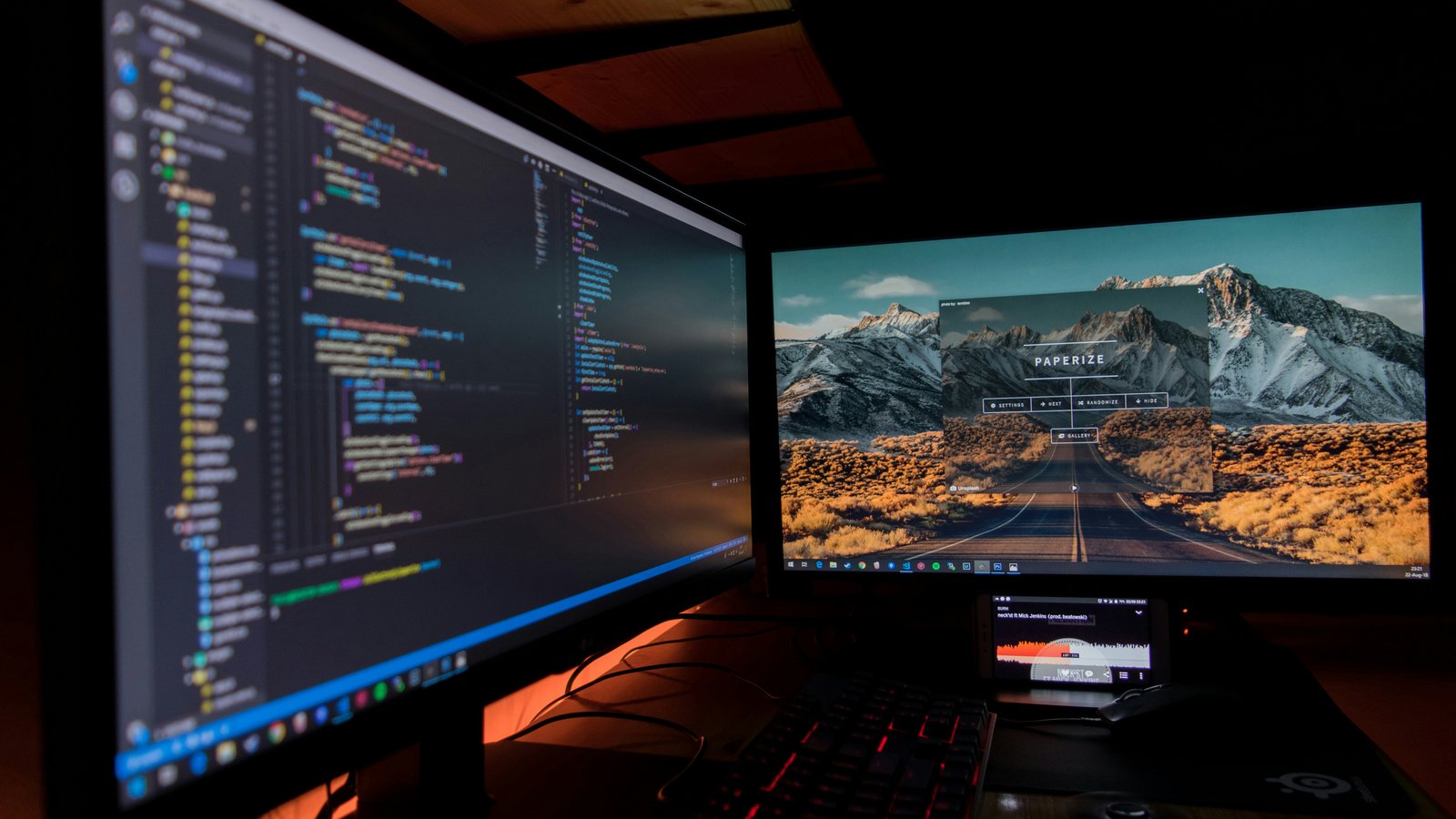 A developer workspace with two monitors displaying code