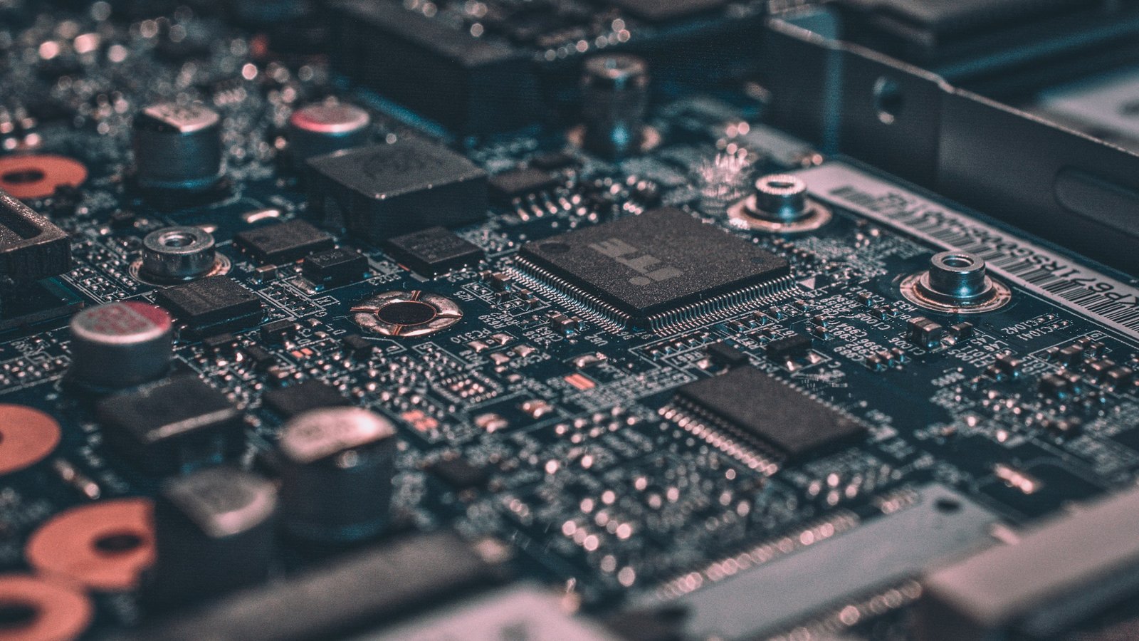 Macro photograph of a dark circuit board with fine copper traces