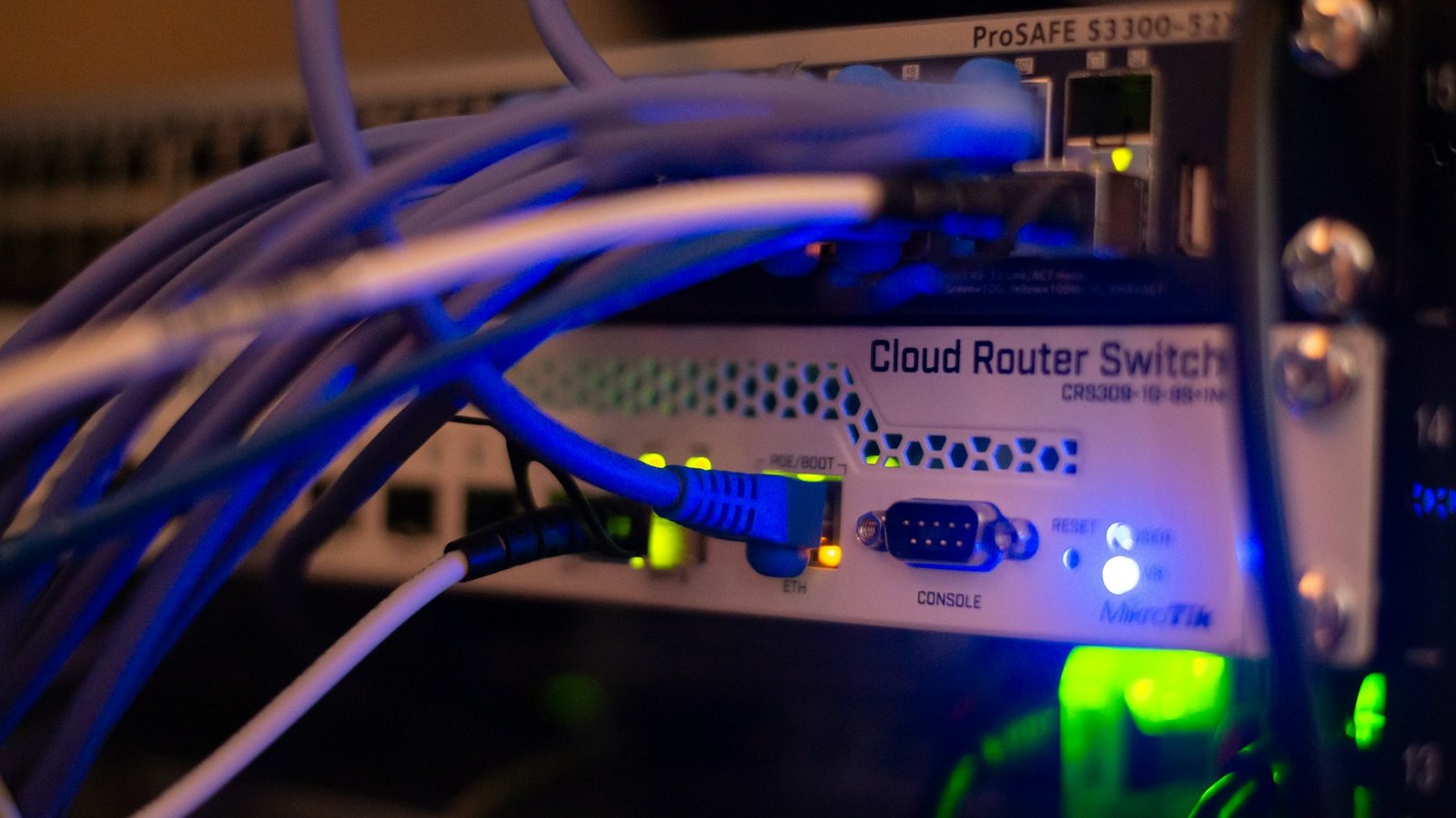 A close-up of a network switch with many cables connected to it