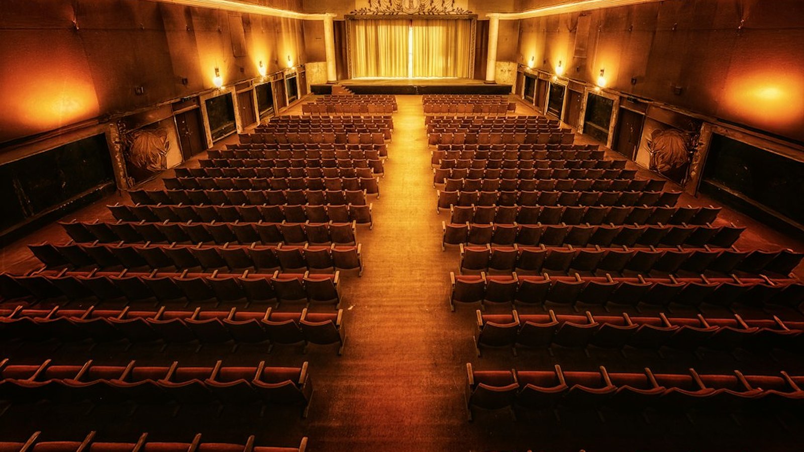 Rows of empty red seats in a vintage theater before a performance